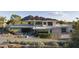 Contemporary home showcasing a modern design with desert landscaping and mountain views at 4451 E Joshua Tree Ln, Paradise Valley, AZ 85253