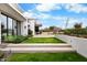 Modern home exterior with pristine lawn, desert landscaping and natural stone walkway leading to the entrance at 4451 E Joshua Tree Ln, Paradise Valley, AZ 85253