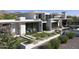 Modern home exterior with clean lines, well-manicured lawn, and lush desert landscaping at 4451 E Joshua Tree Ln, Paradise Valley, AZ 85253