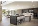 Spacious kitchen showcasing an island with bar seating and a dining area with backyard views at 4451 E Joshua Tree Ln, Paradise Valley, AZ 85253