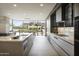 Stylish gourmet kitchen features a large island with modern appliances and adjacent dining space at 4451 E Joshua Tree Ln, Paradise Valley, AZ 85253
