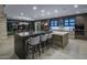 Stylish kitchen featuring a large island with bar seating and access to a dining area at 4451 E Joshua Tree Ln, Paradise Valley, AZ 85253
