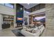 Spacious living room featuring fireplace, built-in shelving, and an abundance of natural light at 4451 E Joshua Tree Ln, Paradise Valley, AZ 85253