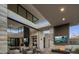 Expansive living room featuring soaring ceilings, stone accents, dual fireplaces, and seamless indoor/outdoor living at 4451 E Joshua Tree Ln, Paradise Valley, AZ 85253