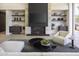 Modern living room with sleek fireplace, stylish shelving, and comfortable seating area at 4451 E Joshua Tree Ln, Paradise Valley, AZ 85253