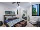 Bright bedroom with queen bed, ceiling fan, accent wall, and large window with a seat at 4451 E Joshua Tree Ln, Paradise Valley, AZ 85253