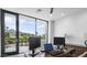 Bright office area features large sliding glass doors and views of the mountain and backyard at 4451 E Joshua Tree Ln, Paradise Valley, AZ 85253