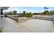 In-ground pool with stone border and desert landscaping, perfect for relaxation and enjoying the outdoor space at 4451 E Joshua Tree Ln, Paradise Valley, AZ 85253