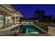 Tranquil in-ground pool at night with outdoor living area and modern house design at 4451 E Joshua Tree Ln, Paradise Valley, AZ 85253