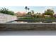Inviting in-ground pool with clean lines and stone accents, nestled in a lush desert landscaped backyard at 4451 E Joshua Tree Ln, Paradise Valley, AZ 85253