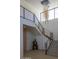 Modern staircase with metal railing and unique chandelier at 4451 E Joshua Tree Ln, Paradise Valley, AZ 85253