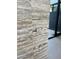 Close-up of travertine wall detailing with light switches and modern door frame at 4451 E Joshua Tree Ln, Paradise Valley, AZ 85253