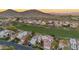 Community aerial view with lush golf course, mountain views, and red tile roofs at 4636 E Monte Way, Phoenix, AZ 85044