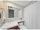 Bright bathroom features a vanity with white mirror, and shower with curtain at 4636 E Monte Way, Phoenix, AZ 85044