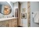 Bathroom features a granite counter, dark wood cabinets, and a round mirror at 5674 N 12Th St, Phoenix, AZ 85014