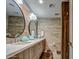 Bathroom featuring dual sinks with round mirrors, wood-look tile, and modern fixtures at 5674 N 12Th St, Phoenix, AZ 85014