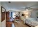 The bedroom features a ceiling fan, bed, sitting area, and desk space at 5674 N 12Th St, Phoenix, AZ 85014