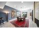Dining room with modern chandelier, large windows, wood-look tile floors and fireplace at 5674 N 12Th St, Phoenix, AZ 85014