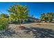 Charming single-story home with a blue-grey tile roof, landscaped yard, and inviting front entryway at 5674 N 12Th St, Phoenix, AZ 85014