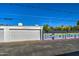 Spacious two-car garage with a white door, set alongside a colorful decorative wall at 5674 N 12Th St, Phoenix, AZ 85014