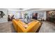 Bright living room features a yellow sectional sofa, hardwood floors, and brick fireplace at 5674 N 12Th St, Phoenix, AZ 85014