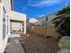Spacious backyard with gravel, covered patio, and lush privacy landscaping at 6455 W Orchid Ln, Glendale, AZ 85302