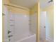Clean white bathroom tub/shower combo with tile surround at 6455 W Orchid Ln, Glendale, AZ 85302
