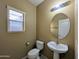 Neutral bathroom with modern fixtures including an updated sink, toilet, and lighting at 6455 W Orchid Ln, Glendale, AZ 85302
