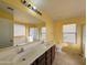 The bathroom features a double sink vanity, large mirror, and a shower/tub at 6455 W Orchid Ln, Glendale, AZ 85302