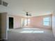 This bedroom features carpet, neutral paint, multiple windows, and a ceiling fan at 6455 W Orchid Ln, Glendale, AZ 85302