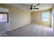 Bedroom with neutral carpet, natural light, and direct access to another room at 6455 W Orchid Ln, Glendale, AZ 85302