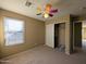 Bedroom with carpet, large window and closet at 6455 W Orchid Ln, Glendale, AZ 85302