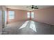 This bedroom features carpet, neutral paint, multiple windows, and a ceiling fan at 6455 W Orchid Ln, Glendale, AZ 85302