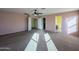 This bedroom features carpet, neutral paint, and attached bathroom and closet at 6455 W Orchid Ln, Glendale, AZ 85302