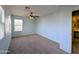 Bedroom with carpet, a ceiling fan, and direct access to the bathroom at 6455 W Orchid Ln, Glendale, AZ 85302