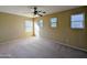 Bedroom with neutral carpet, ample natural light, and a ceiling fan at 6455 W Orchid Ln, Glendale, AZ 85302