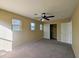 Cozy bedroom features neutral carpet, a ceiling fan, and a closet at 6455 W Orchid Ln, Glendale, AZ 85302