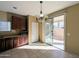Bright breakfast nook with outdoor access and view of backyard. Dark cabinets and granite countertops at 6455 W Orchid Ln, Glendale, AZ 85302