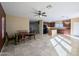 The open concept room shows the dining area adjacent to a kitchen with dark wood cabinets at 6455 W Orchid Ln, Glendale, AZ 85302