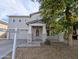 Two-story home featuring neutral stucco, covered entry with columns, and a decorative front door at 6455 W Orchid Ln, Glendale, AZ 85302