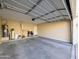 Spacious two car garage with open door, storage, and utilities at 6455 W Orchid Ln, Glendale, AZ 85302