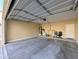 Spacious two car garage with open door, utilities, and work area at 6455 W Orchid Ln, Glendale, AZ 85302