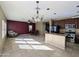 Open floorplan with living, dining, and kitchen area with stainless appliances and tiled floors at 6455 W Orchid Ln, Glendale, AZ 85302