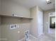 Laundry area with a shelf, connections for a washer/dryer, and tile floors at 6455 W Orchid Ln, Glendale, AZ 85302