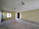 Spacious living area with plush carpeting, natural light, and neutral wall color at 6455 W Orchid Ln, Glendale, AZ 85302
