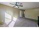 This spacious loft features neutral paint, carpet, a ceiling fan, and natural light at 6455 W Orchid Ln, Glendale, AZ 85302