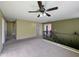 This spacious loft features neutral paint, carpet, a ceiling fan, and multiple doorways at 6455 W Orchid Ln, Glendale, AZ 85302