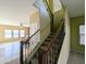Carpeted staircase with a decorative wooden handrail and view into the open floor plan at 6455 W Orchid Ln, Glendale, AZ 85302