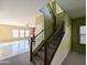 Carpeted staircase with dark wood banister leading to upper level, with an adjacent dining area at 6455 W Orchid Ln, Glendale, AZ 85302