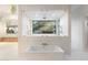 Luxurious bathroom with soaking tub and walk-in shower, offering scenic views at 6516 E Meadowlark Ln, Paradise Valley, AZ 85253